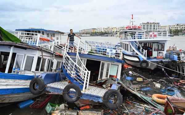 A man checks his damaged boat after Typhoon Yagi hit Ha Long bay, in Vietnam on 8 September, 2024.